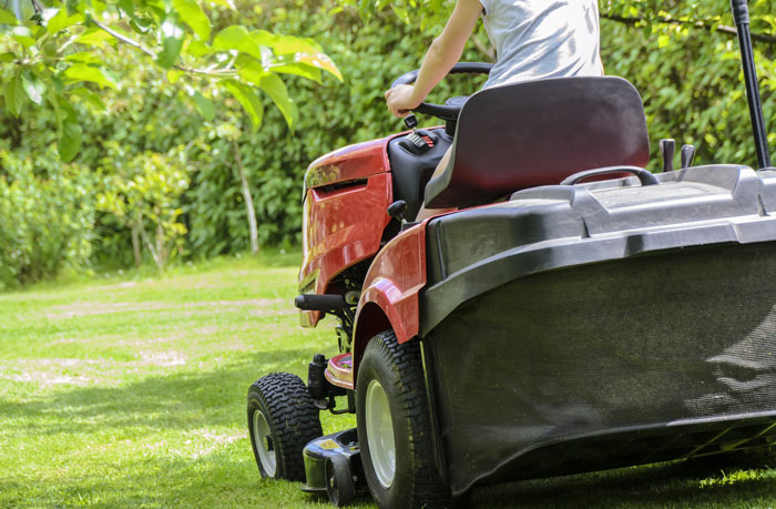 spring lawn care tips mowing yard on riding mower